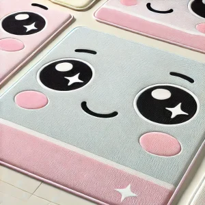Grey and pink bathroom mat with a cute face.